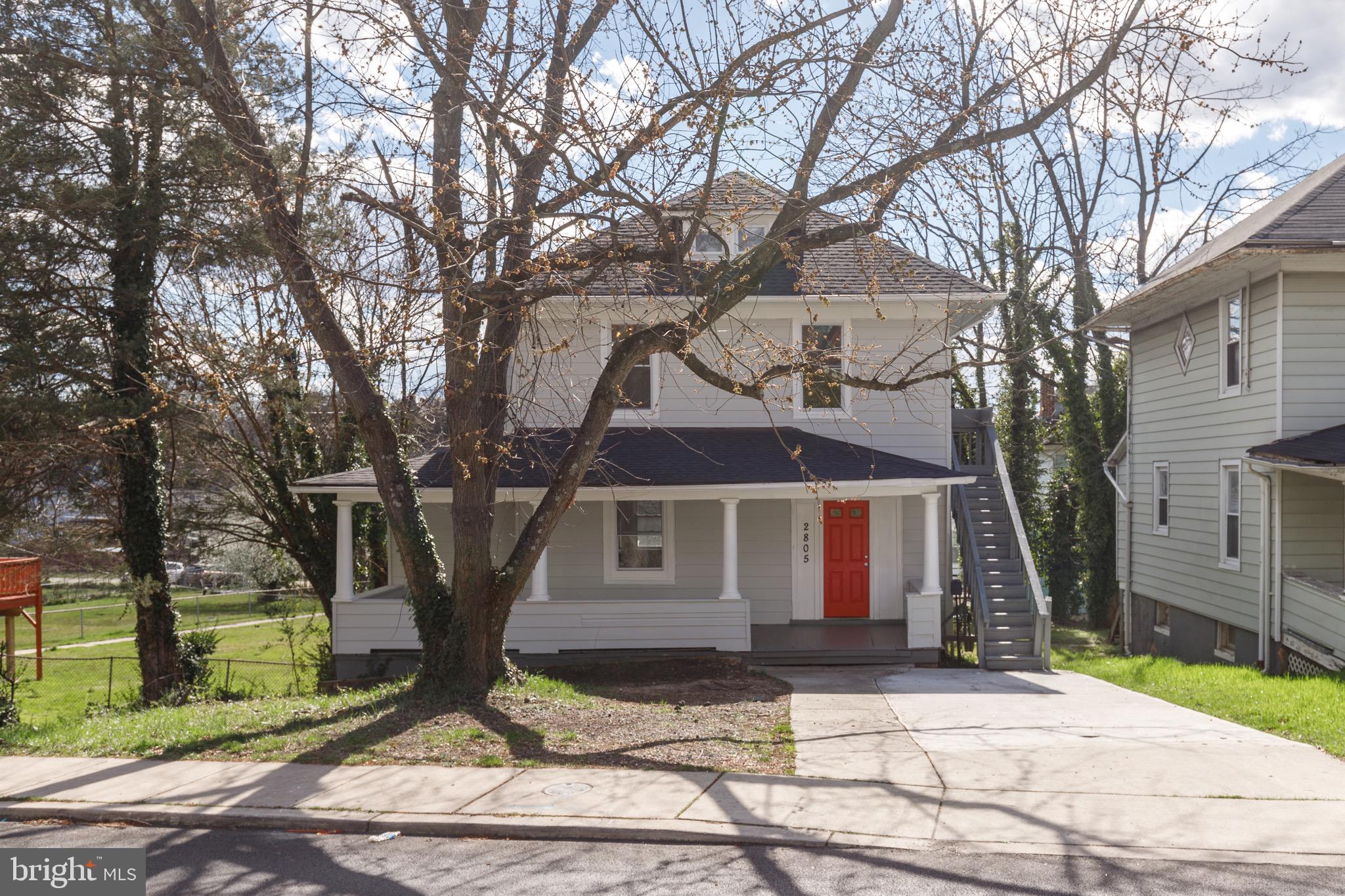 2805 Hamilton Avenue Baltimore, MD 21214 - Photo 10 of 41 a front view of a house with a tree