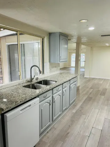 a bathroom with a granite countertop sink a mirror and a