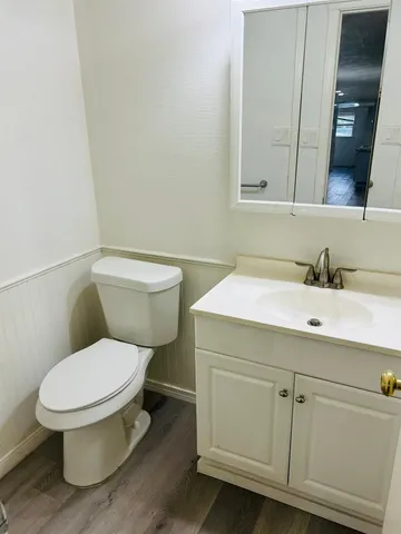 a white toilet sitting next to a bathroom sink