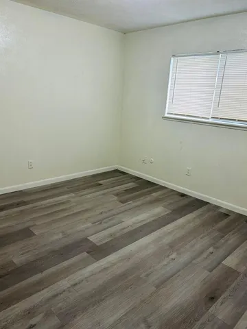 a view of a room with wooden floor