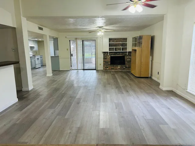 wooden floor in an empty room with a fireplace