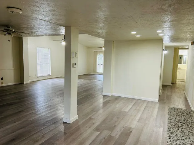 wooden floor in an empty room with a window