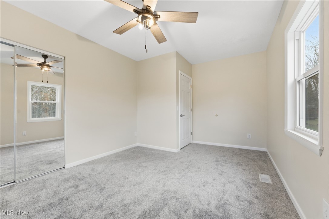 3793 Ranfield Road Kent, OH 44240 - Photo 29 of 40 Empty room with light carpet and ceiling fan