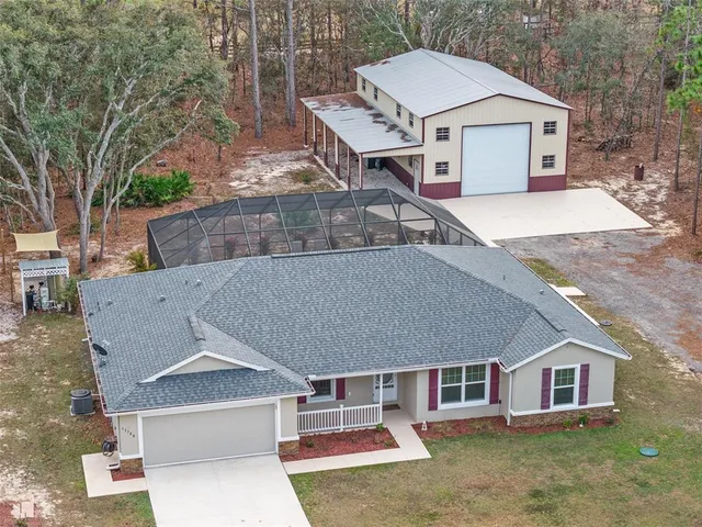 an aerial view of a house with a yard