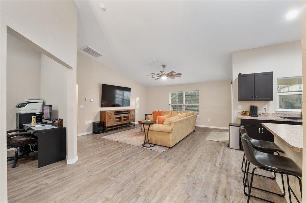 13700 Southwest 71st Lane Ocala, FL 34481 - Photo 14 of 100 a living room with furniture a flat screen tv and kitchen view