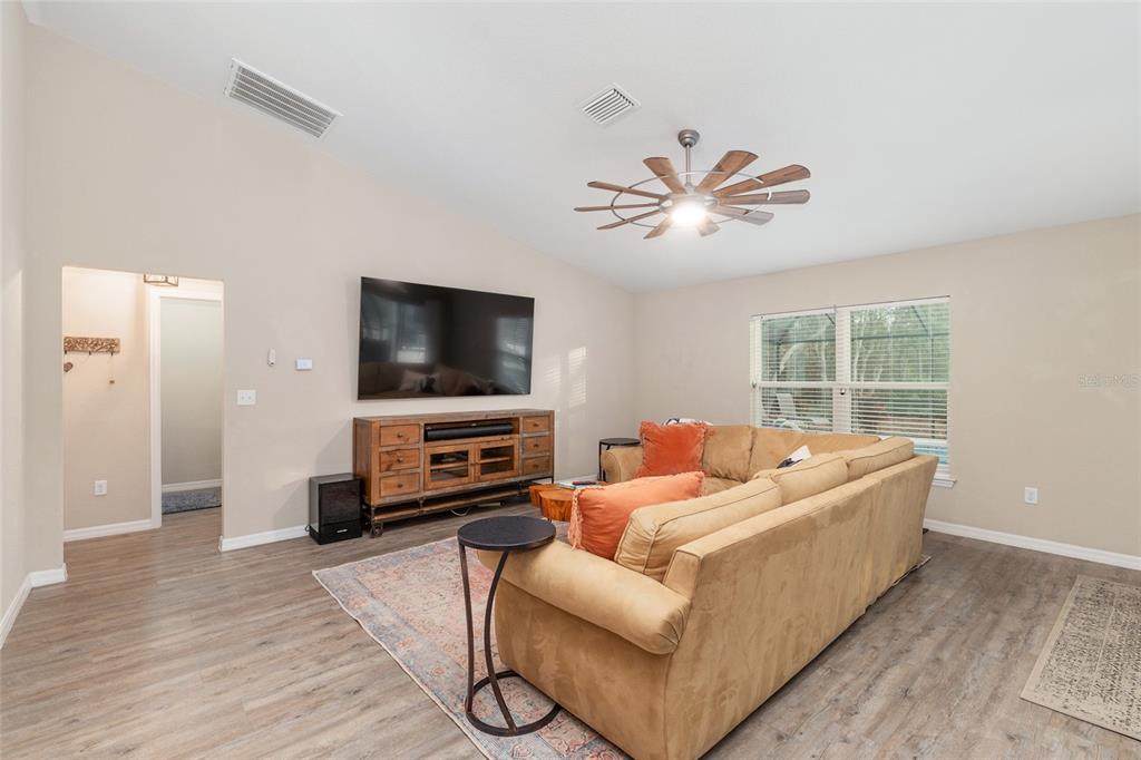 13700 Southwest 71st Lane Ocala, FL 34481 - Photo 15 of 100 a living room with furniture and a flat screen tv