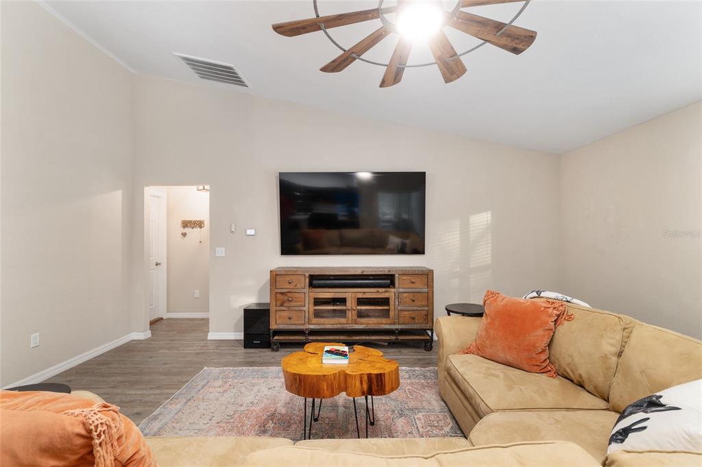 13700 Southwest 71st Lane Ocala, FL 34481 - Photo 16 of 100 a living room with furniture and a flat screen tv