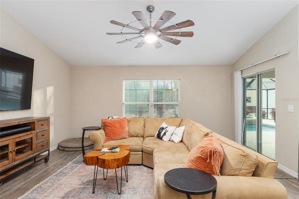 13700 Southwest 71st Lane Ocala, FL 34481 - Photo 18 of 100 a living room with furniture and a flat screen tv