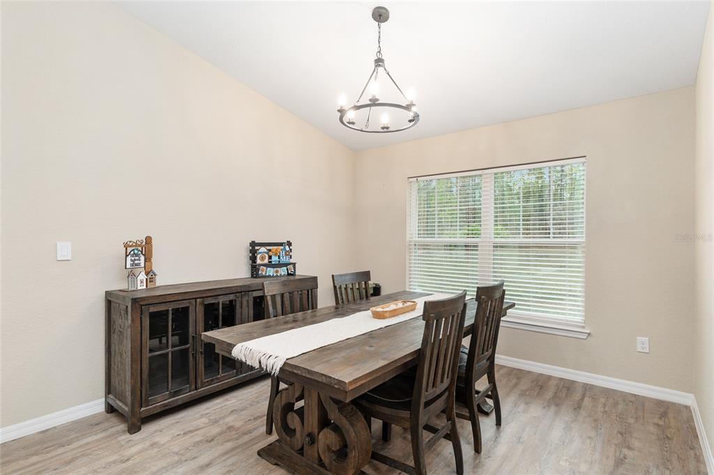 13700 Southwest 71st Lane Ocala, FL 34481 - Photo 20 of 100 a view of a dining room with furniture window and wooden floor
