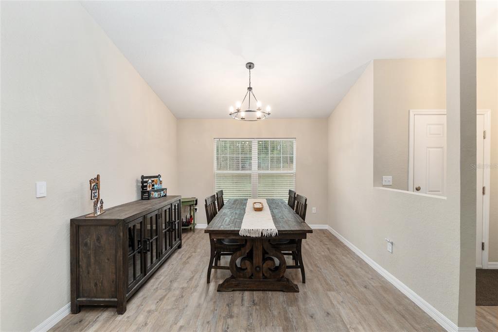 13700 Southwest 71st Lane Ocala, FL 34481 - Photo 21 of 100 a dining room with furniture window and wooden floor