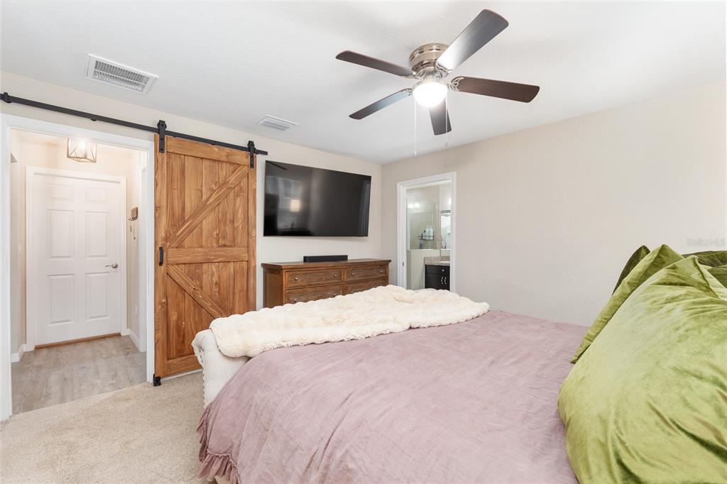 13700 Southwest 71st Lane Ocala, FL 34481 - Photo 32 of 100 a bedroom with a bed window and a flat screen tv