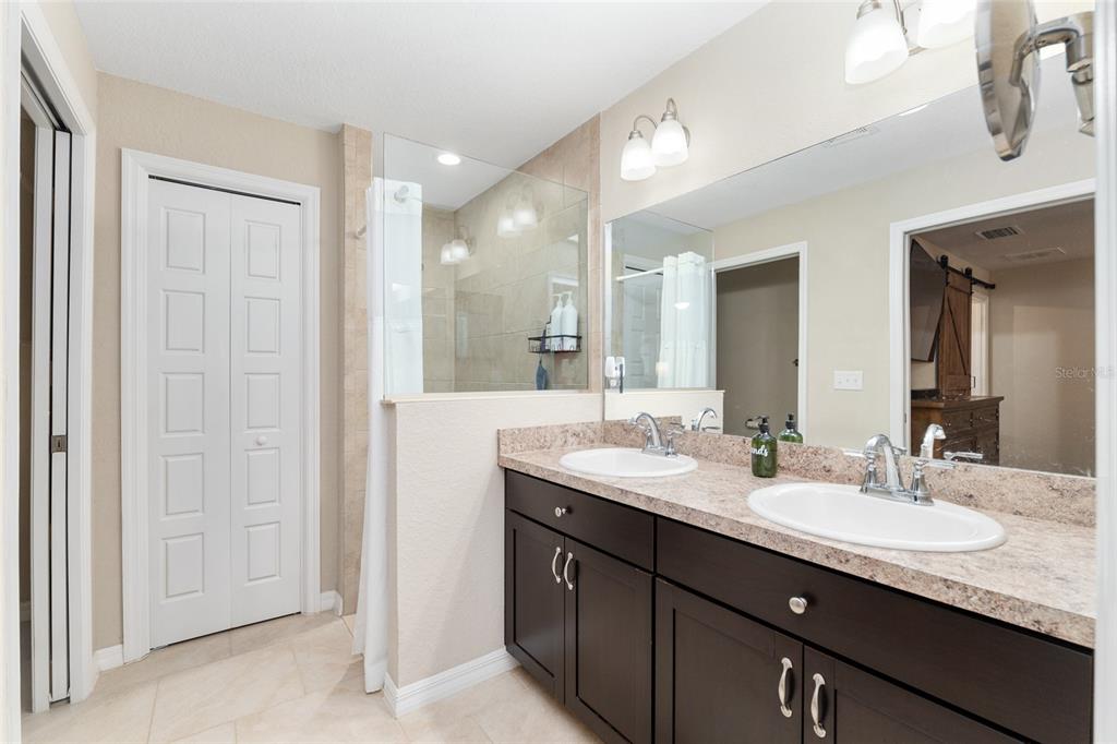 13700 Southwest 71st Lane Ocala, FL 34481 - Photo 35 of 100 a bathroom with double vanity sinks and a mirror