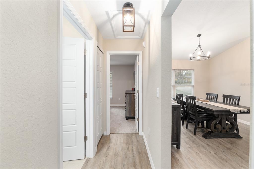 13700 Southwest 71st Lane Ocala, FL 34481 - Photo 43 of 100 a view of a hallway with furniture and wooden floor