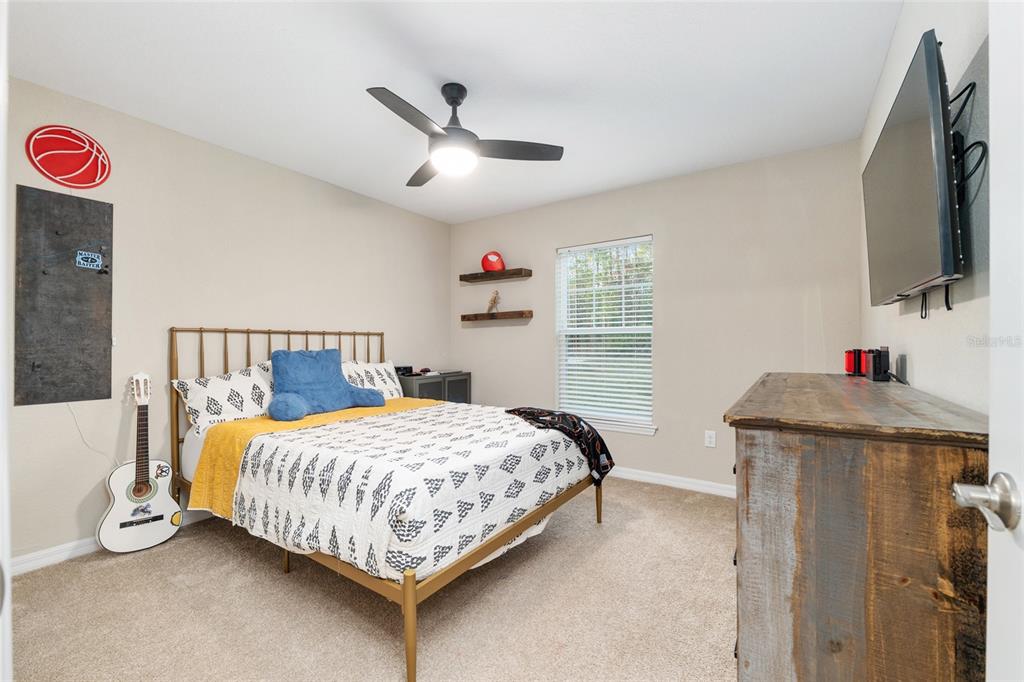 13700 Southwest 71st Lane Ocala, FL 34481 - Photo 46 of 100 a bedroom with a bed and a flat screen tv