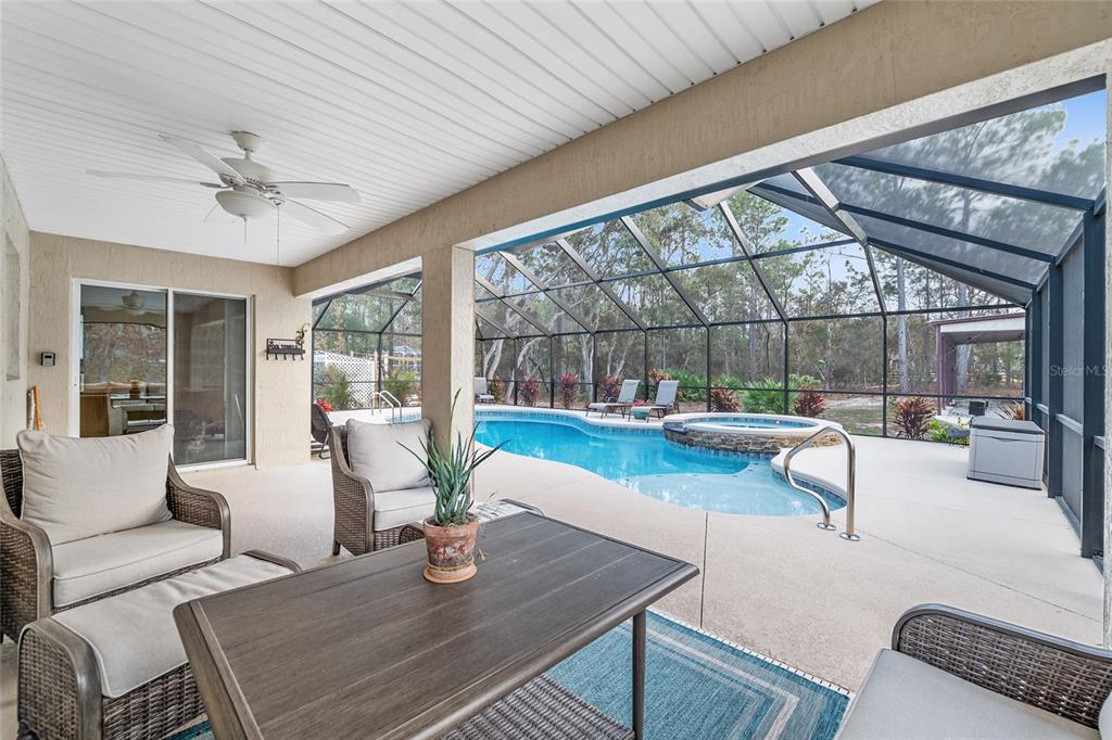 13700 Southwest 71st Lane Ocala, FL 34481 - Photo 54 of 100 a view of a dining room with furniture large windows and wooden floor