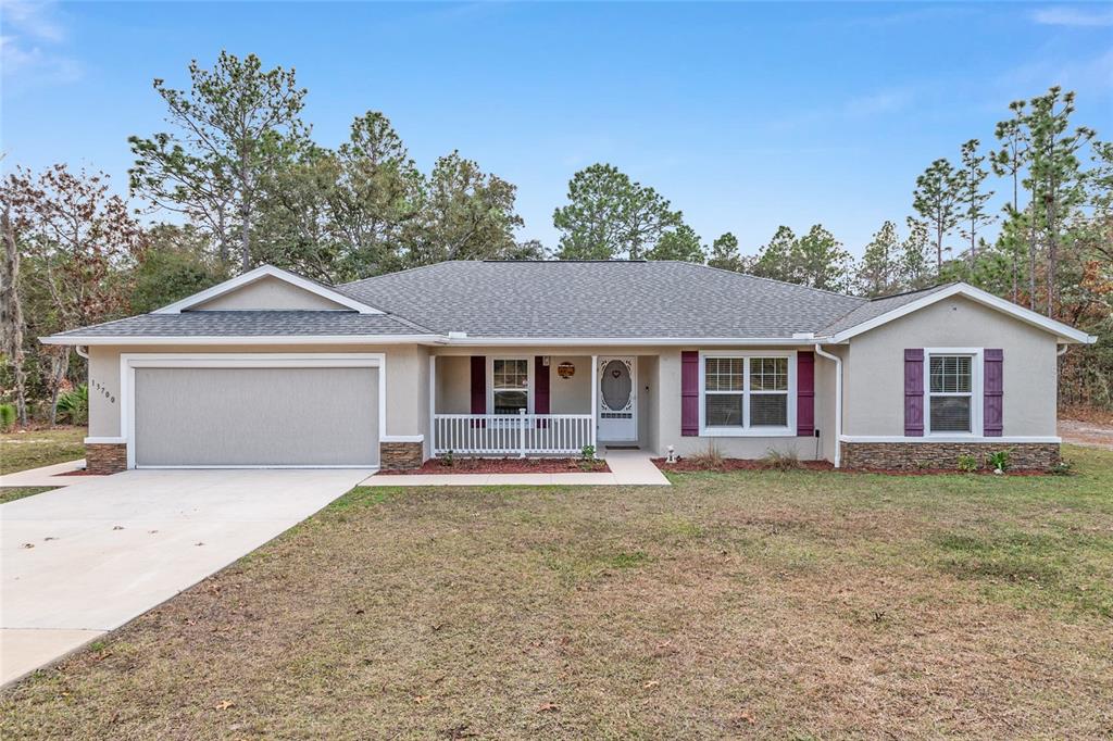 13700 Southwest 71st Lane Ocala, FL 34481 - Photo 6 of 100 a front view of a house with a yard and garage