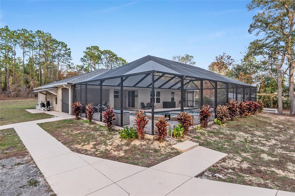 13700 Southwest 71st Lane Ocala, FL 34481 - Photo 70 of 100 a view of a house with backyard porch and sitting area