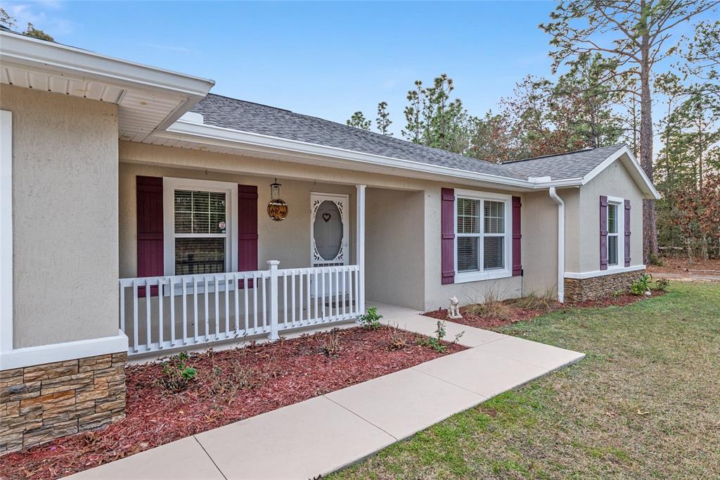 13700 Southwest 71st Lane Ocala, FL 34481 - Photo 8 of 100 a view of a house with a small yard and wooden fence
