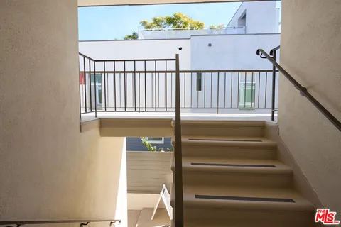 a view of a livingroom with furniture and stairs