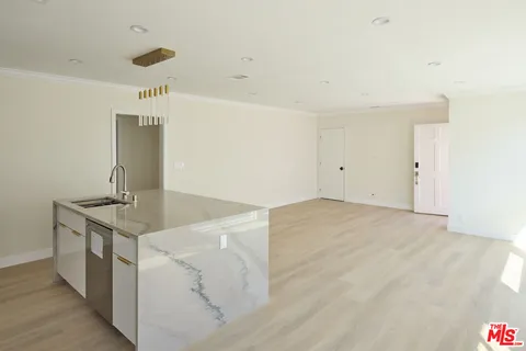 a kitchen with granite countertop a sink and a stove