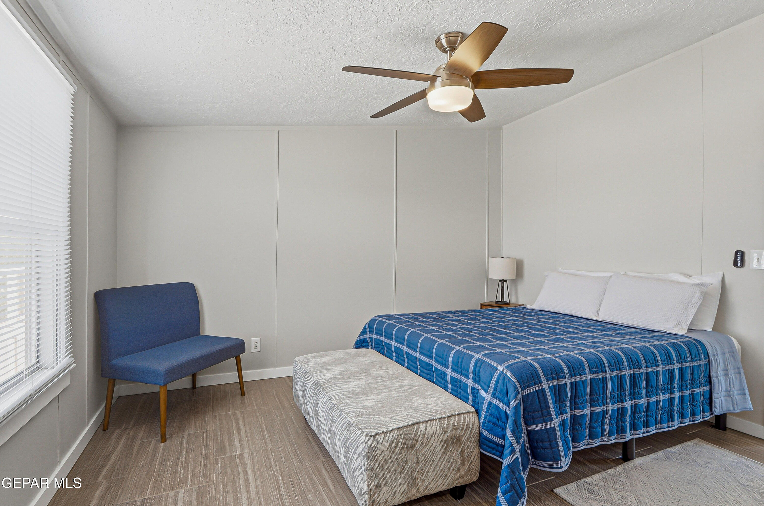 2901 Cook Street Truth or Consequences, NM 87901 - Photo 23 of 31 a bedroom with a bed a chair and a potted plant