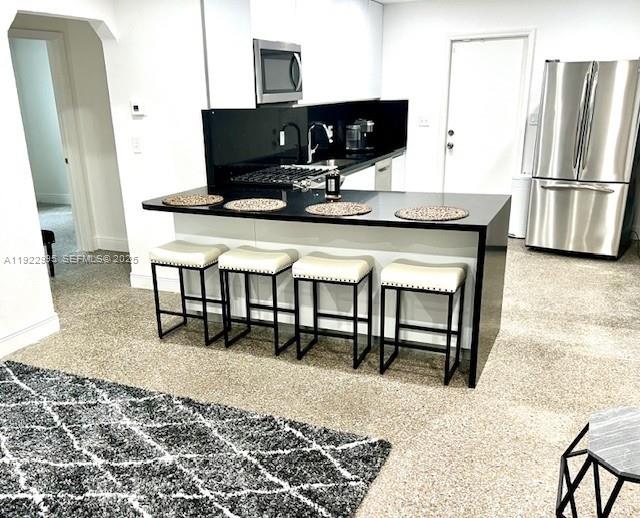 3711 Southwest 58th Avenue Davie, FL 33314 - Photo 1 of 40 a kitchen with stainless steel appliances granite countertop a refrigerator table and chairs