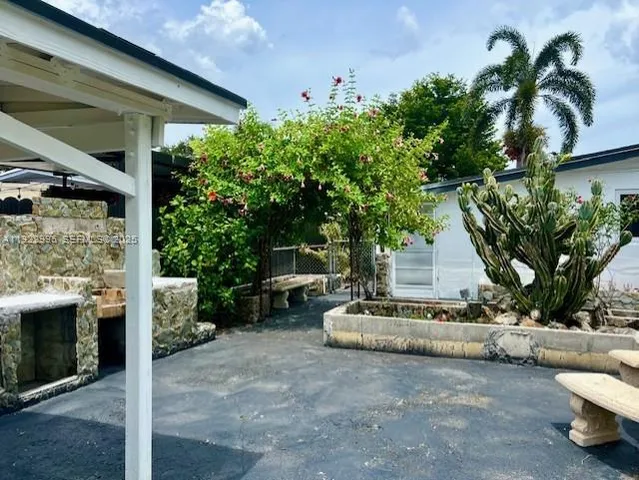 a view of a house with backyard and sitting area