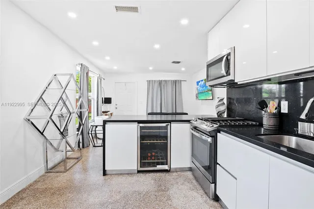 a kitchen with stainless steel appliances granite countertop a stove and a refrigerator