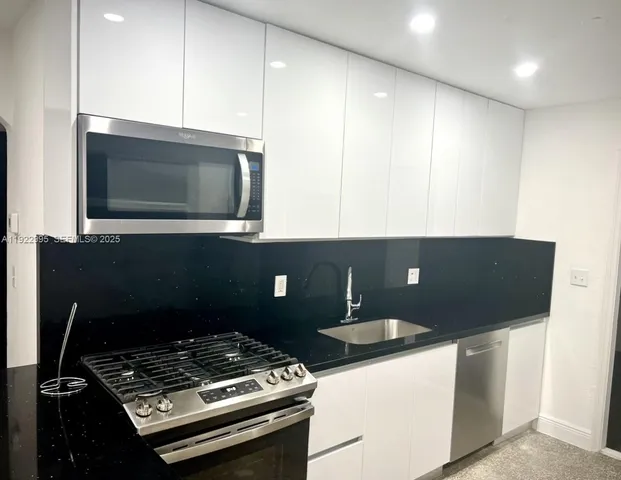a stove top oven sitting inside of a kitchen