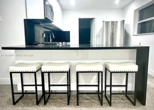 a kitchen with a table and chairs