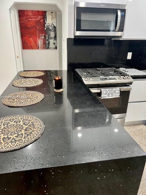 3711 Southwest 58th Avenue Davie, FL 33314 - Photo 6 of 40 a kitchen with a stove and a microwave