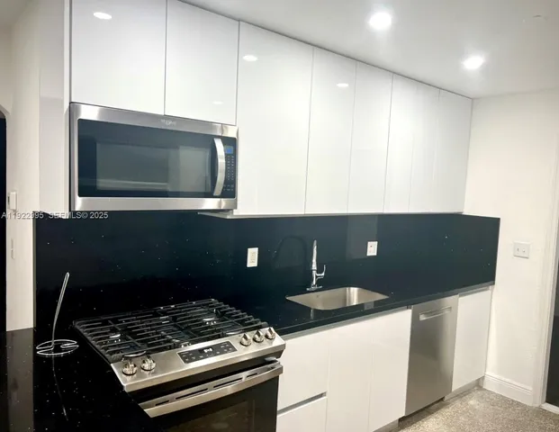 a stove top oven sitting inside of a kitchen