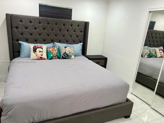 a bedroom with a bed and dresser