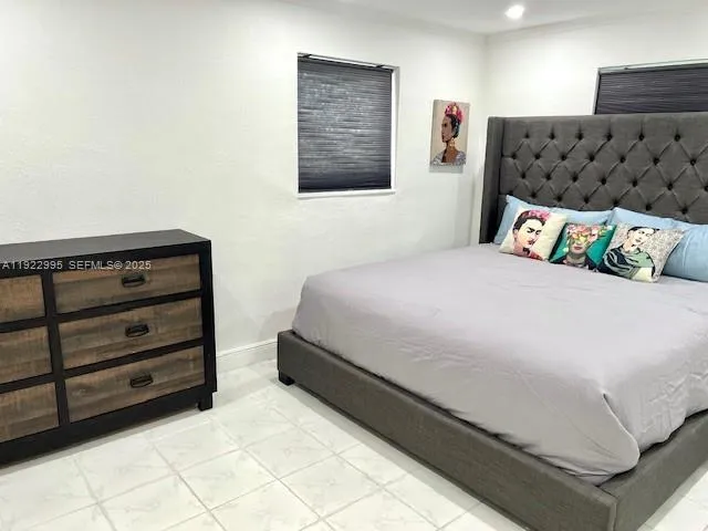 a bedroom with a bed and dresser