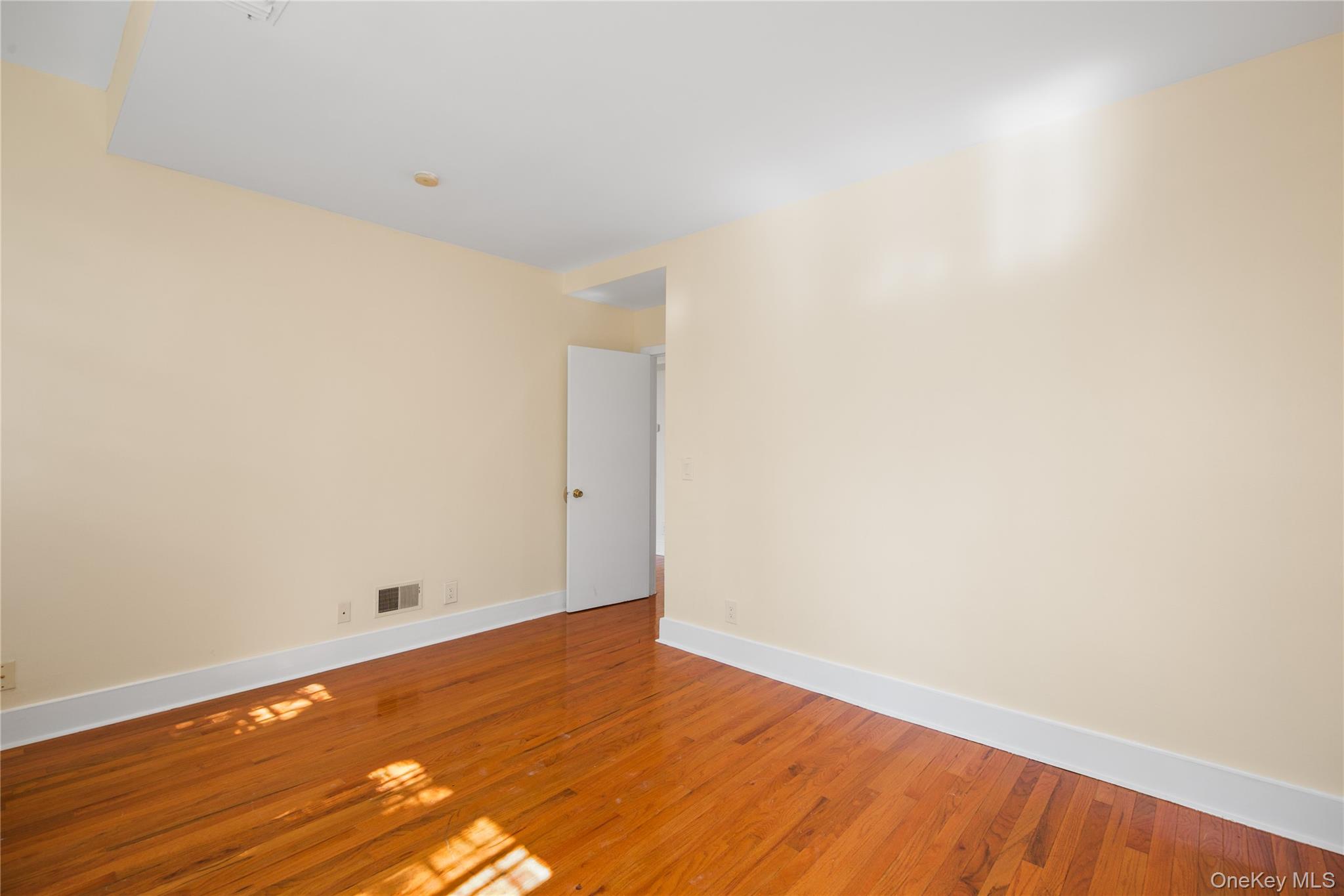 207 Chateau Rive, Unit 207 Peekskill, NY 10566 - Photo 11 of 16 a view of an empty room with wooden floor