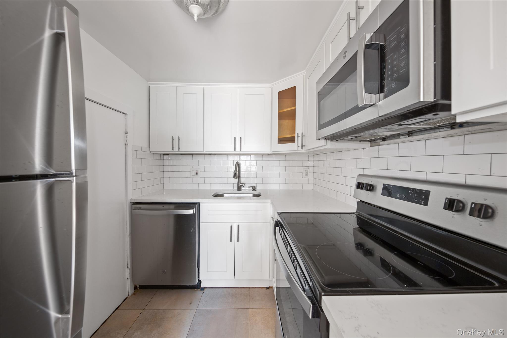 207 Chateau Rive, Unit 207 Peekskill, NY 10566 - Photo 8 of 16 a kitchen with a stove microwave and refrigerator