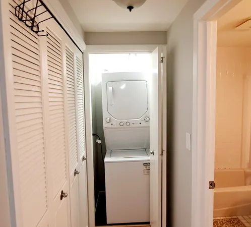 a view of a hallway with a washer and dryer
