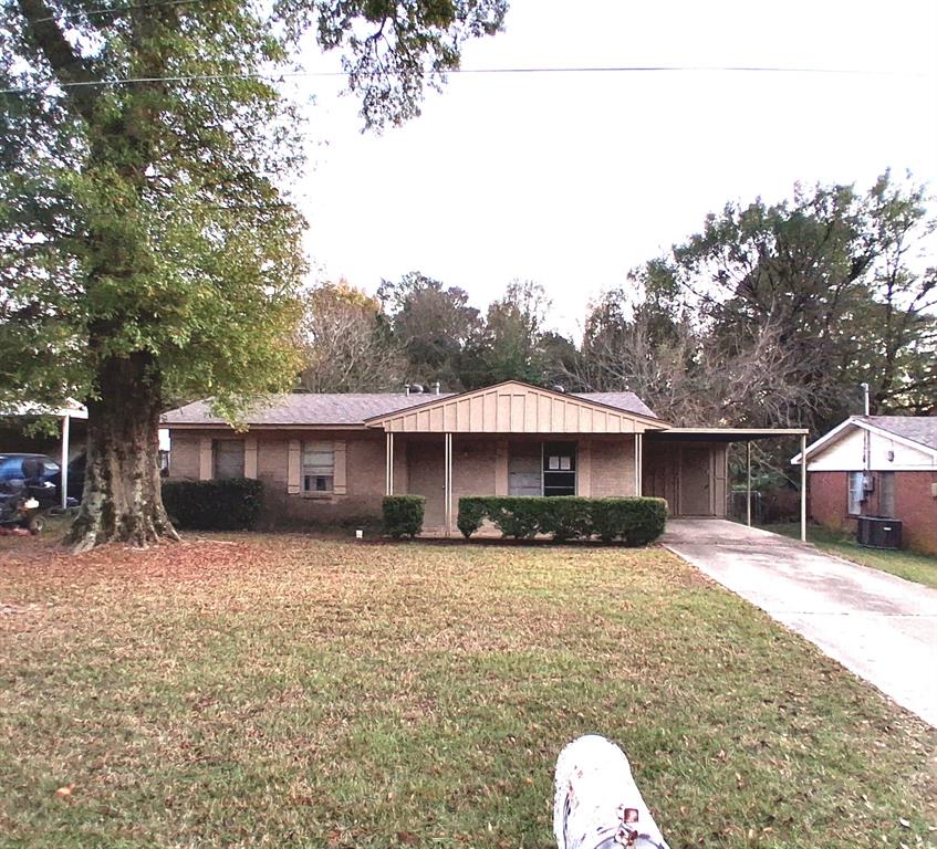 a front view of a house with a yard covered in snow
