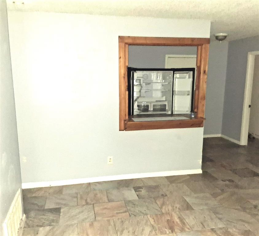 135 Akins Road Texarkana, TX 75501 - Photo 4 of 12 a view of an empty room with a window