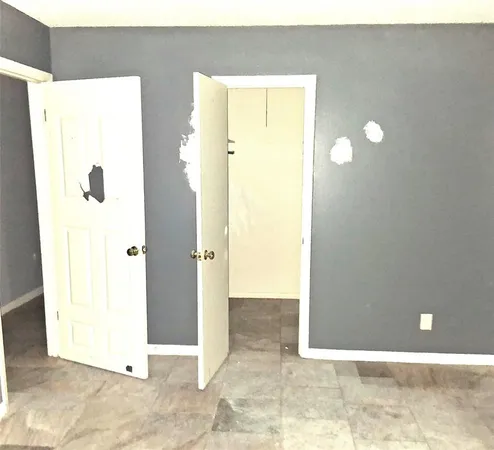 a view of a hallway with two windows