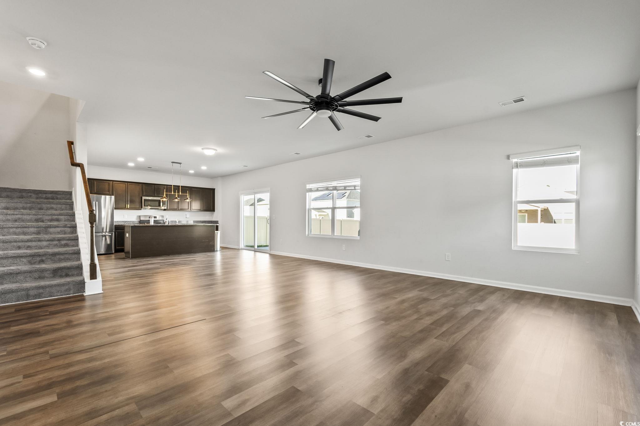 733 Lambeth Lane Conway, SC 29526 - Photo 11 of 40 Unfurnished living room with stairway, dark wood-style floors, recessed lighting, and a ceiling fan