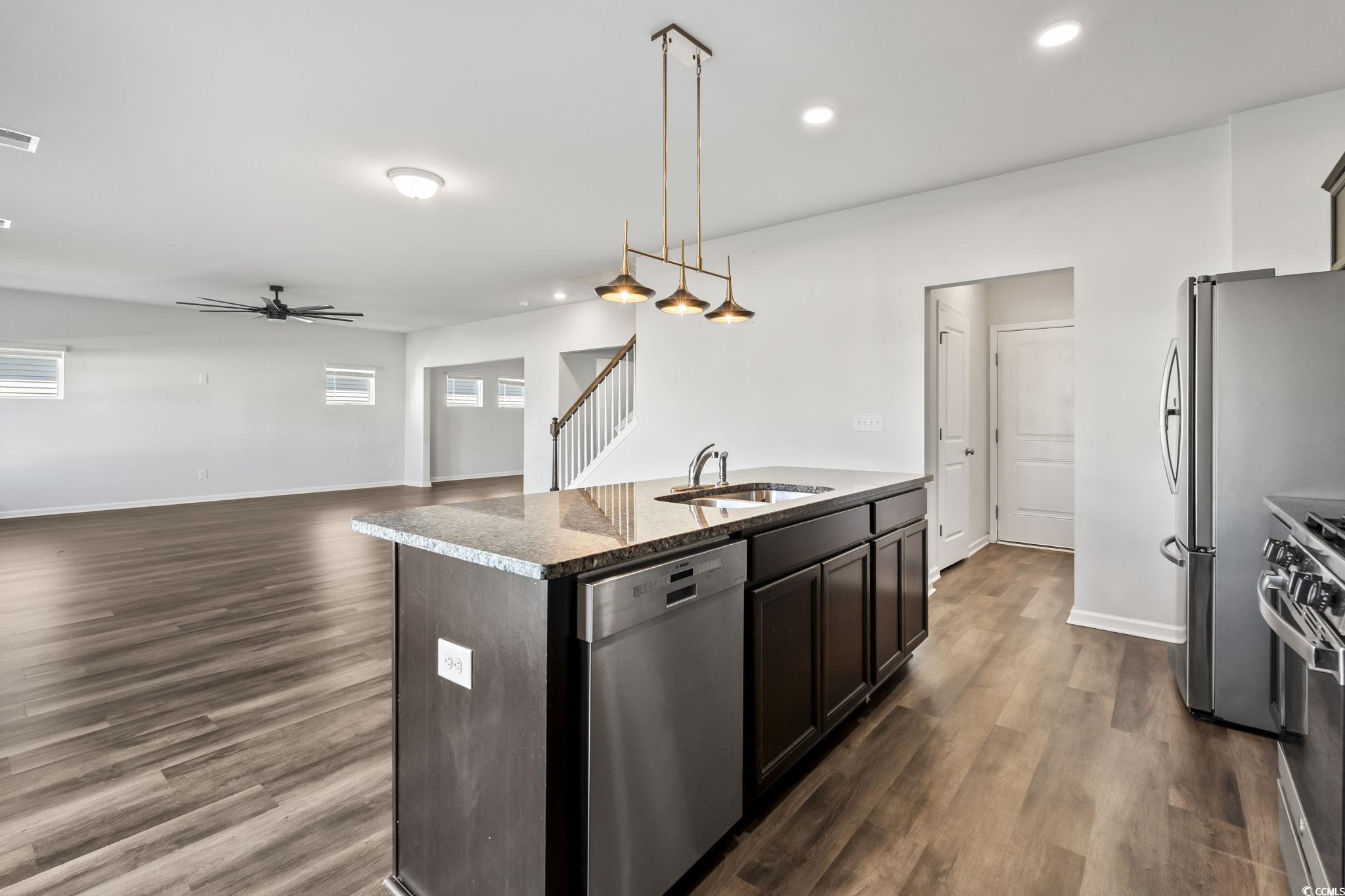 733 Lambeth Lane Conway, SC 29526 - Photo 16 of 40 Kitchen with decorative light fixtures, a center island with sink, appliances with stainless steel finishes, recessed lighting, and dark wood-style flooring