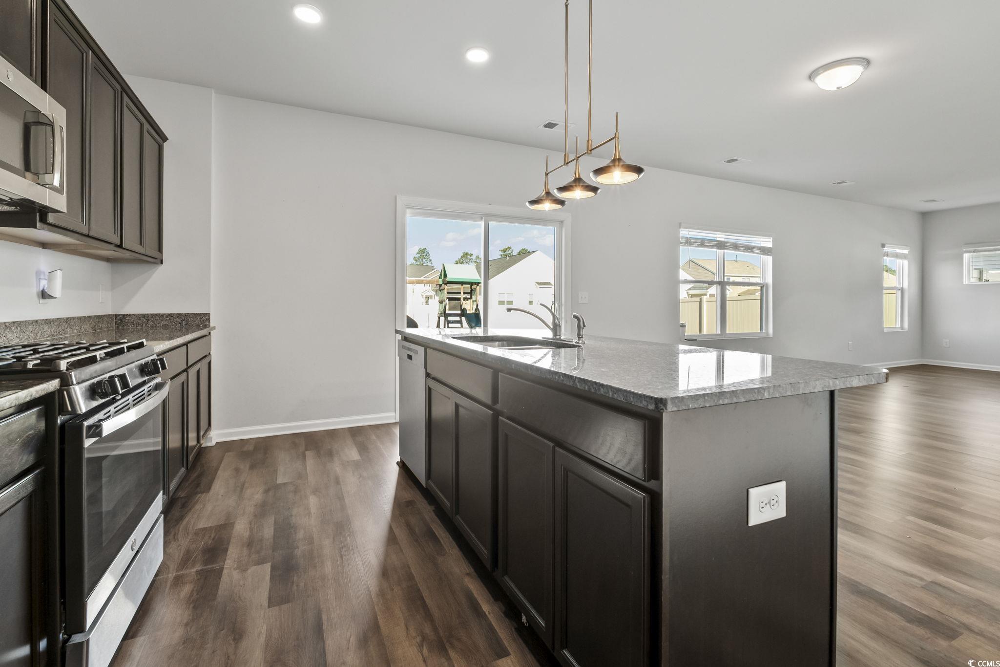 733 Lambeth Lane Conway, SC 29526 - Photo 17 of 40 Kitchen featuring decorative light fixtures, appliances with stainless steel finishes, a center island with sink, plenty of natural light, and recessed lighting