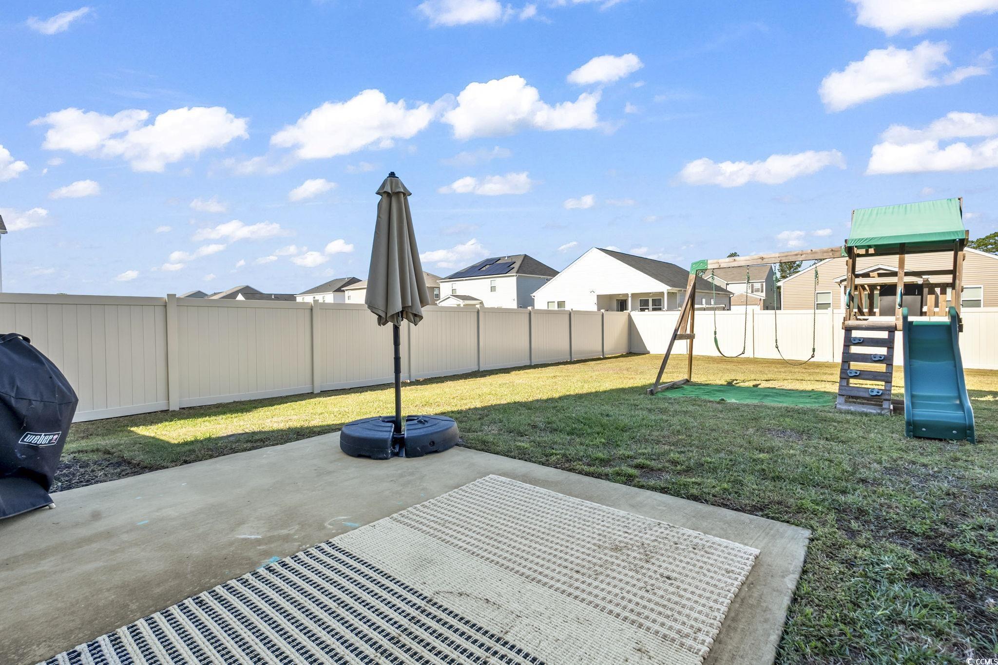 733 Lambeth Lane Conway, SC 29526 - Photo 35 of 40 Fenced backyard with a residential view, a patio, and a playground