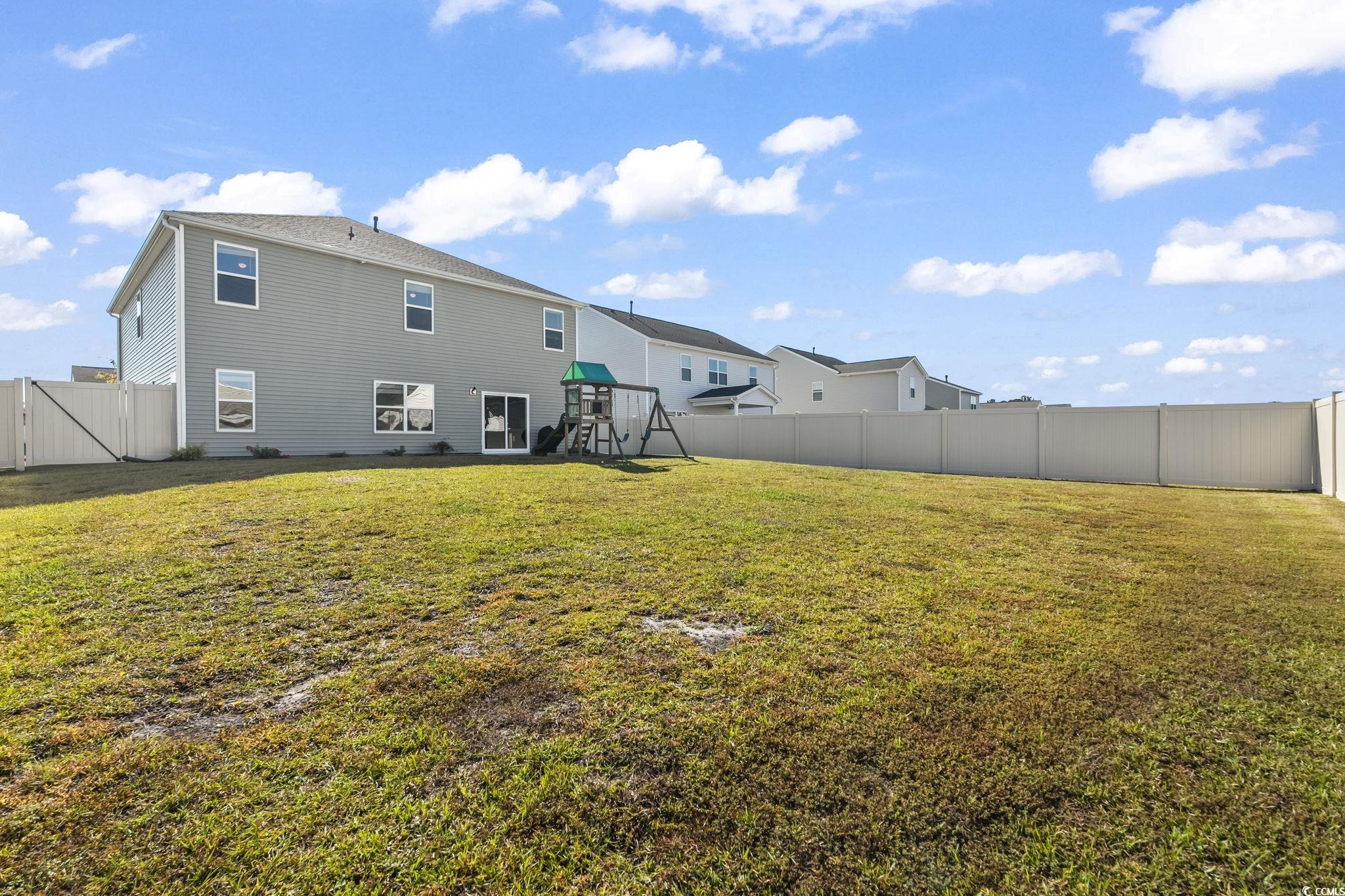 733 Lambeth Lane Conway, SC 29526 - Photo 37 of 40 Back of property with a fenced backyard, a playground, and a gate