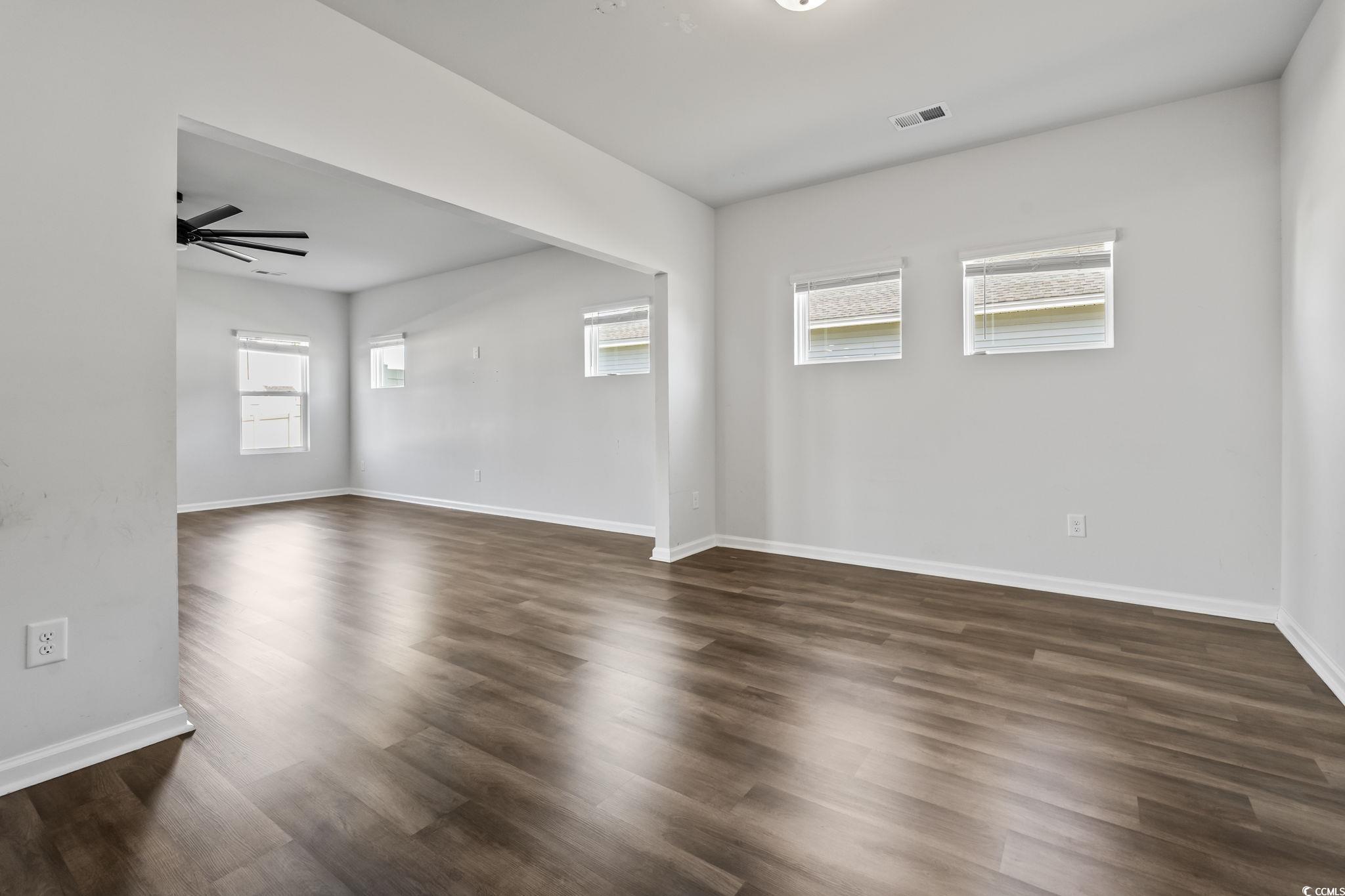733 Lambeth Lane Conway, SC 29526 - Photo 5 of 40 Unfurnished room with dark wood-style floors and a ceiling fan