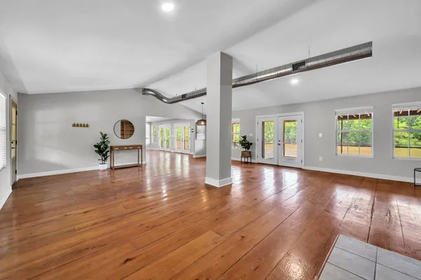 a view of wooden floor and windows in a room