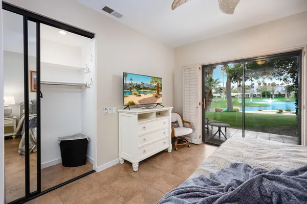a view of a bedroom with furniture and windows