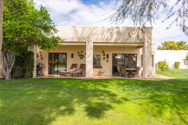 a view of a house with swimming pool and a porch