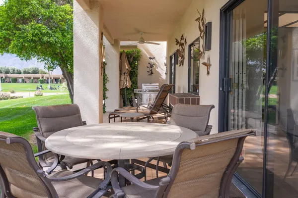 a view of a patio with table and chairs